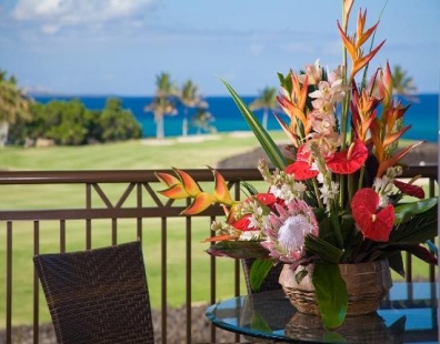 balcony table with vase of flowers. view of golf course.