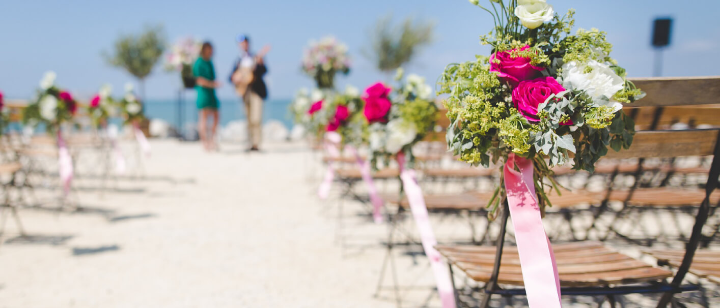 beach wedding setup with aisle bouquets